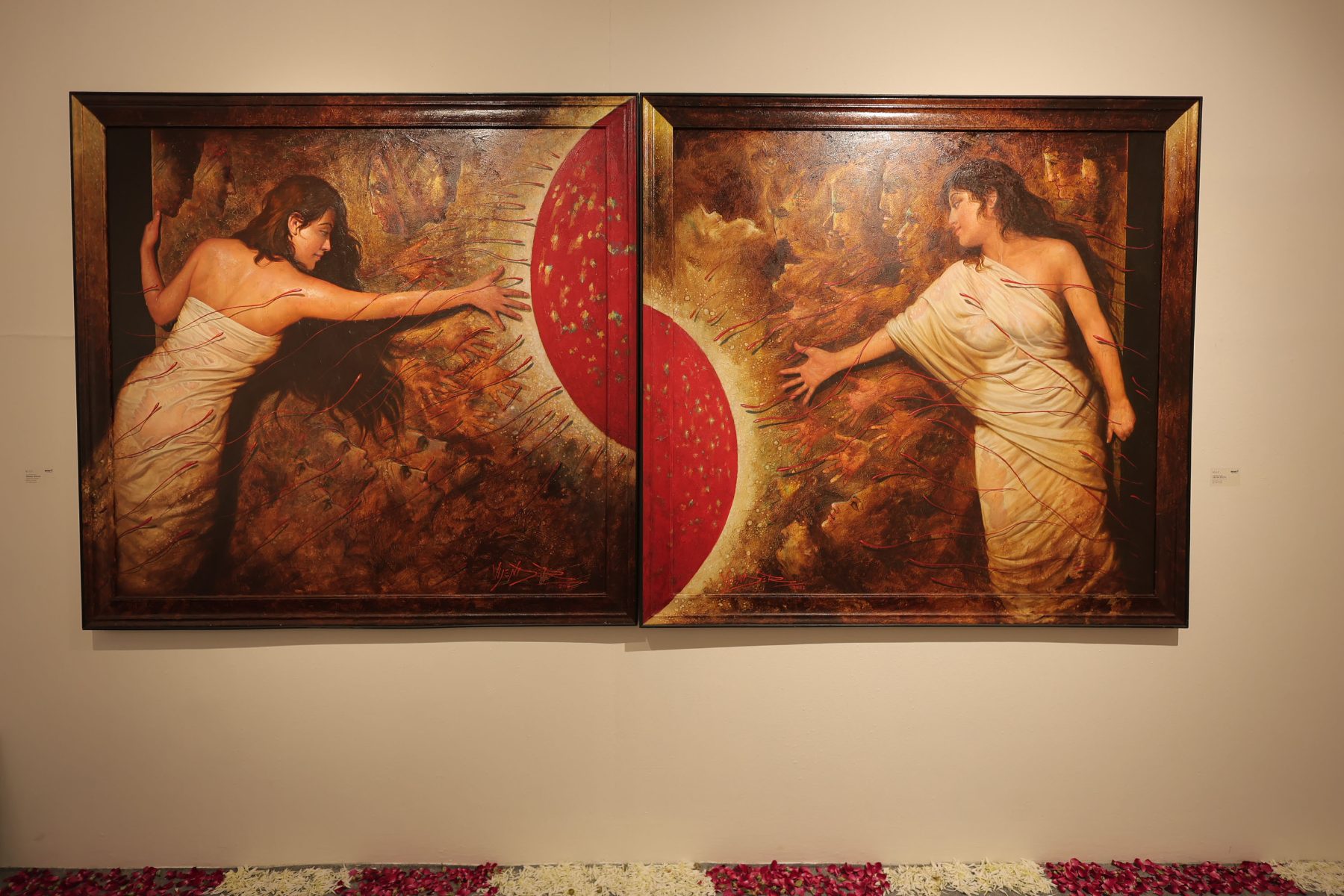 A diptych of two women reaching toward a red sun