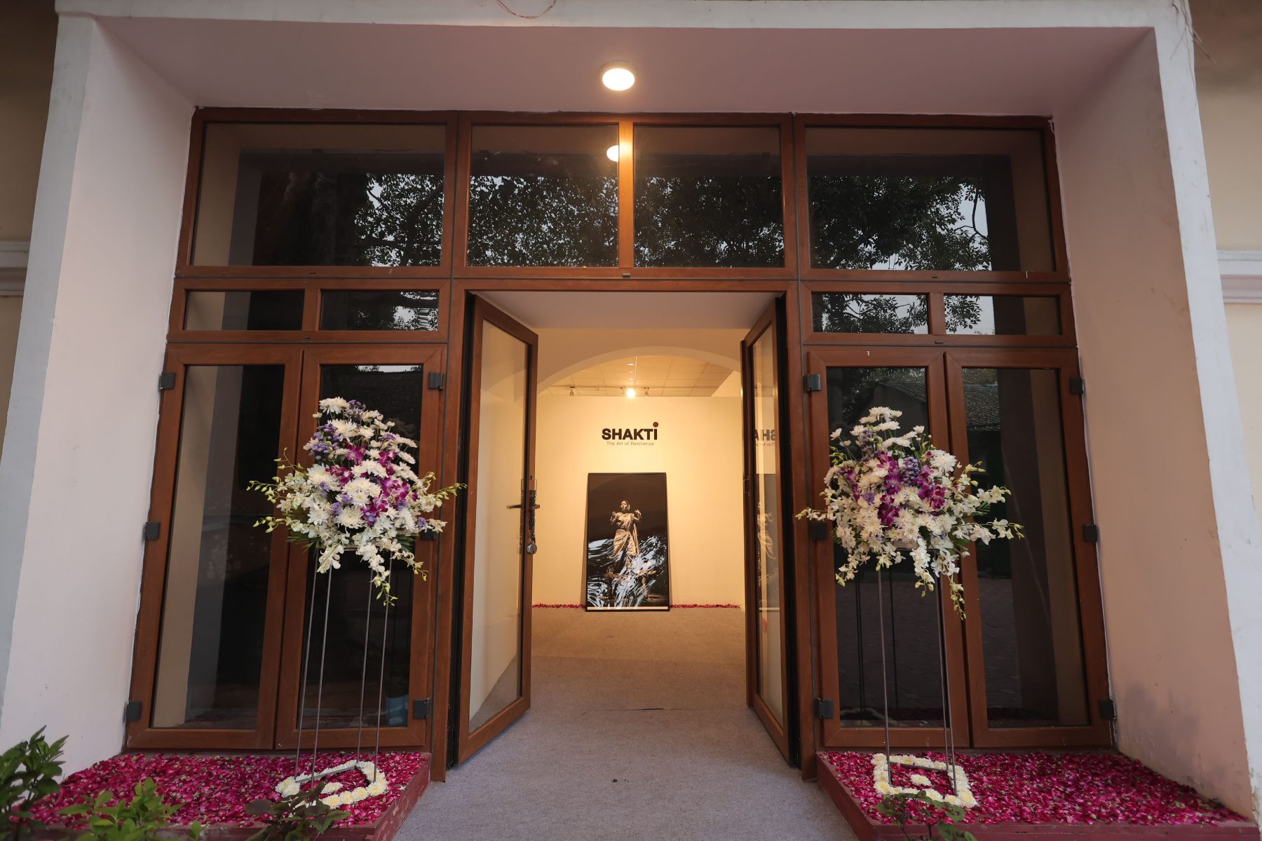 The open doors of the Living Tradition Centre, the SHAKTI sign and a Lavani portrait glowing inside