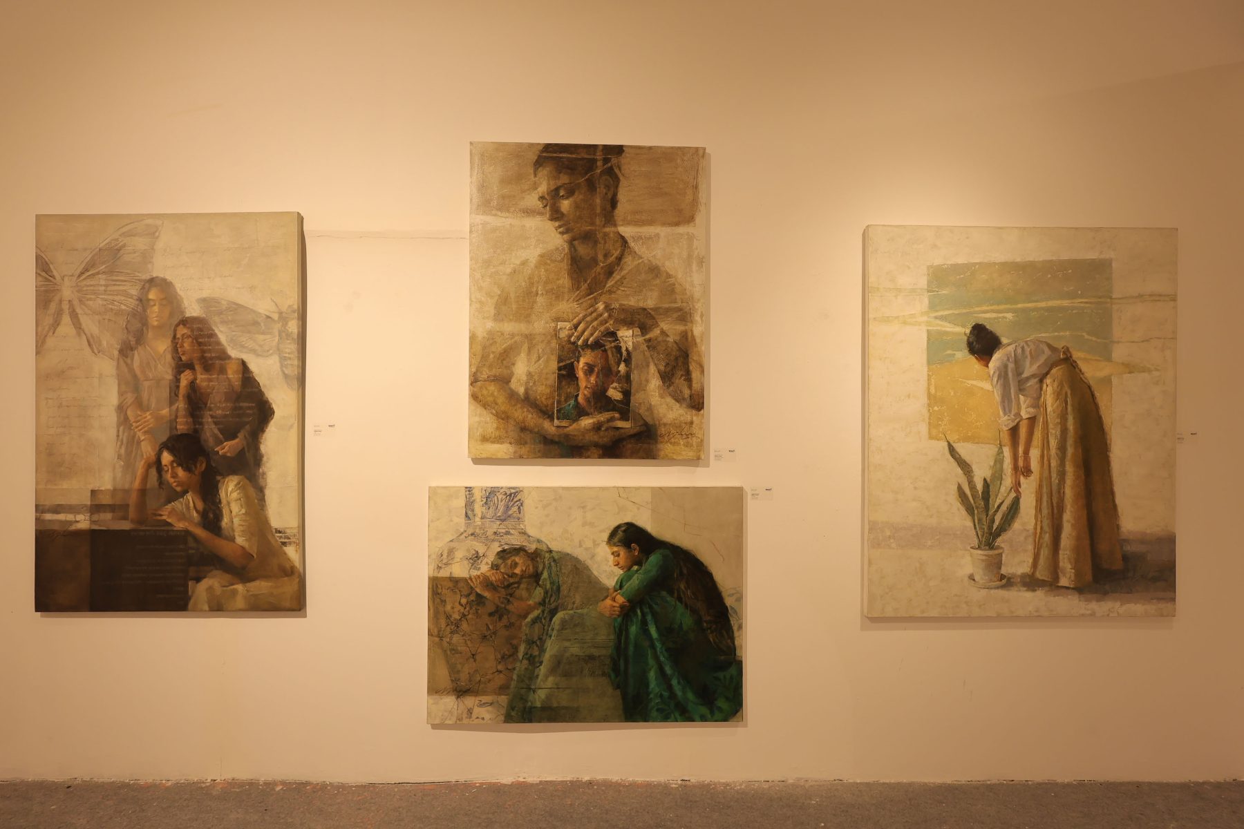Four canvases of women in muted, layered oils